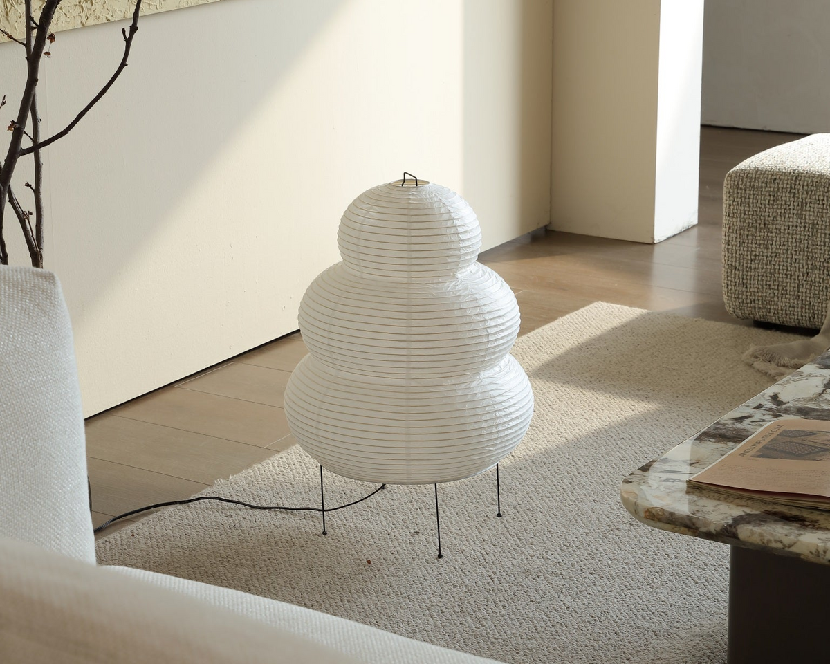 Kumo washi paper floor lamp unlit, showing its sculptural cloud shape in a living room corner