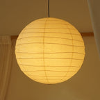 Hüga Collective Akari handmade paper ceiling lamp with light on. In bedroom lighting. 
