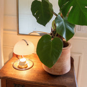 Curva candle warmer lamp melting a candle on a kitchen counter